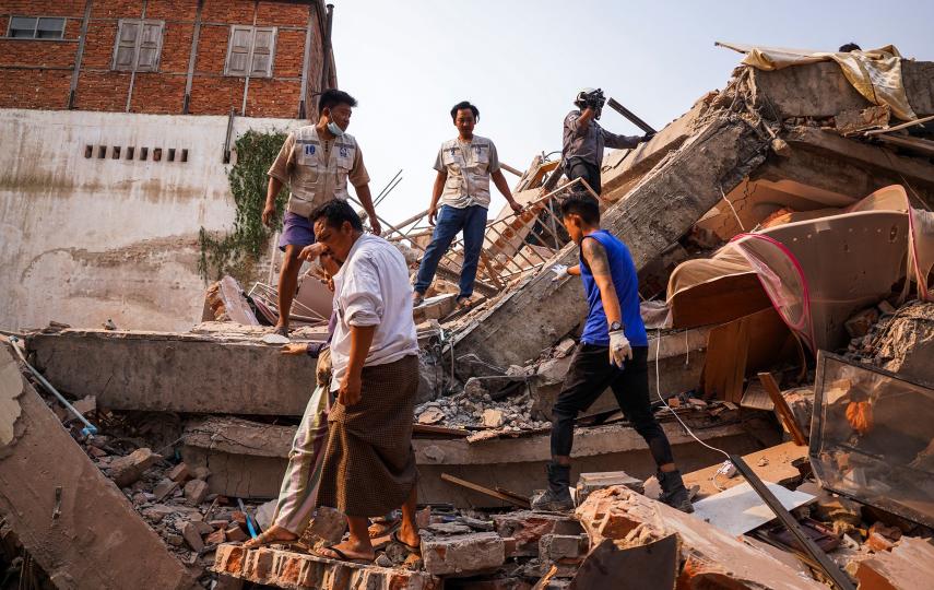 Rescuers work at the site of a building that collapsed, in the aftermath of a strong earthquake, in Mandalay, Myanmar, March 30.