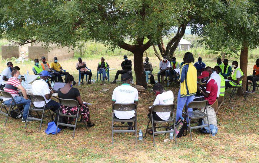 Refugee leaders sit outdoors at a meeting in Mpevi, western Uganda. R