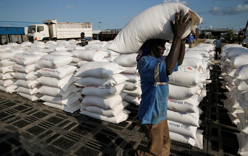 A man carries sacks of food aid for distribution to Internally displaced people (IDPs) in the POC (Protection of Civilians) Camp, run by the UN Mission in South Sudan near the town of Malakal, in the Upper Nile state of South Sudan, September 9, 2018.