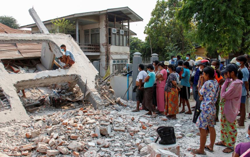 People stand by a collapsed building after a strong earthquake, near its epicenter, in Sagaing, Myanmar, March 31, 2025. 