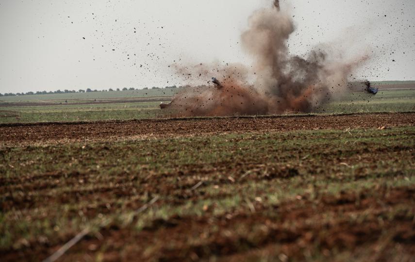 The photo shows a bomb being exploded by a landmine clearance team in Syria.