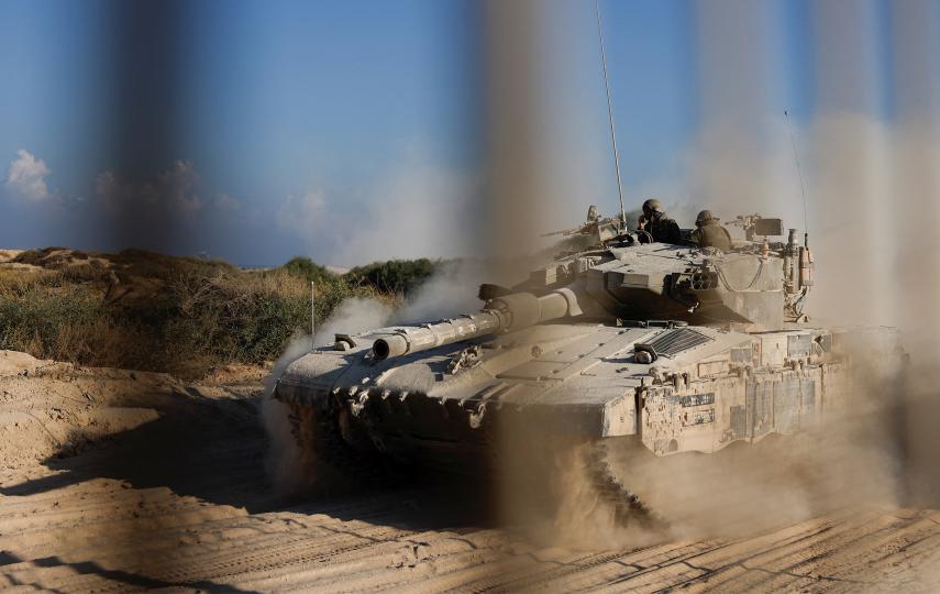 An Israeli tank manoeuvres before entering into the Gaza Strip, amid the ongoing conflict in Gaza between Israel and Hamas, at the Kerem Shalom crossing in southern Israel, November 11, 2024.