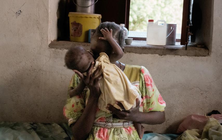A woman called Tati holds her young daughter Nahid while playing in a malnutrition ward of the Cap Anamur hospital In Kauda, South Kordofan.