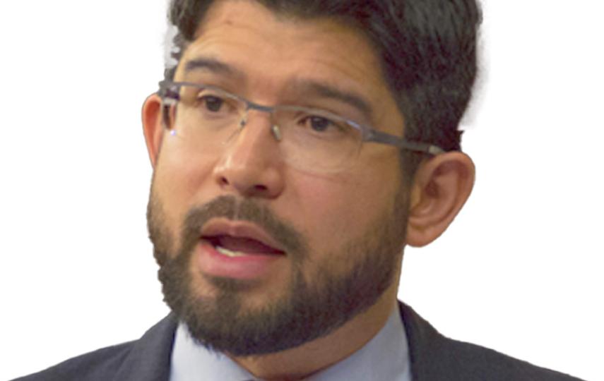 A headshot of Carlos Menchaca mid-speech.
