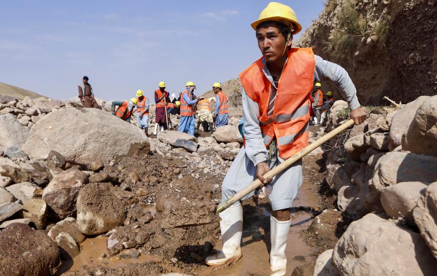 An Afghan worker employed on a project run by World Vision digs a trench in a riverbed near Khwaja Shahab, a village in the western province of Herat, on 20 October 2024.