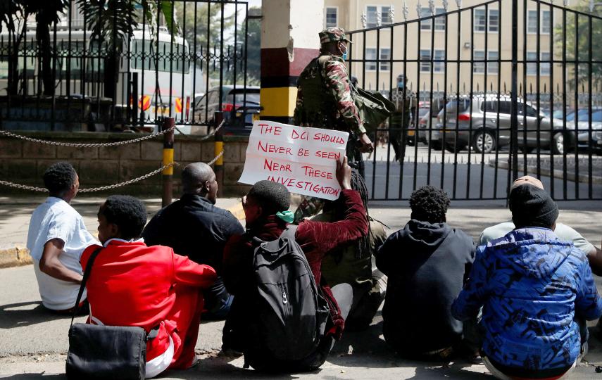 Protesters sit outside the police headquarters in Nairobi as they demonstrate on 12 June 2025 against the death of teacher Albert Ojwang' in police custody the week before.