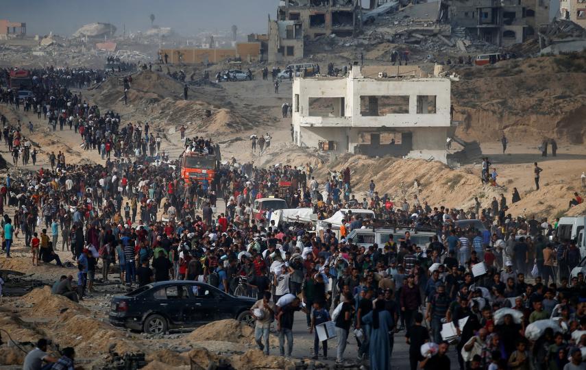 Palestinians gather to receive aid supplies in Beit Lahia, in the northern Gaza Strip, on 22 June 2025.