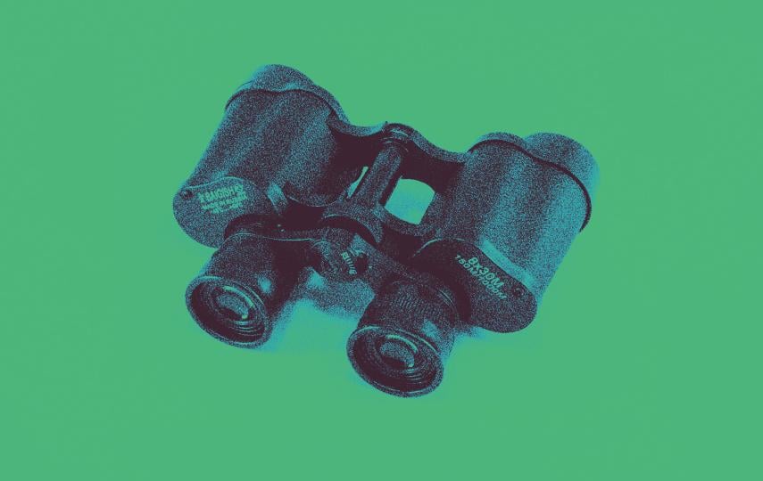 The image shows a pair of vintage binoculars placed on a flat surface against a solid background. The binoculars are black and appear heavily stylized with a blue duotone filter, giving them a bold, high-contrast appearance. The object casts a subtle blue shadow, enhancing the visual depth. The overall effect is artistic and graphic, with a pop art or retro-inspired aesthetic, focusing on the form and texture of the binoculars through heavy digital processing.