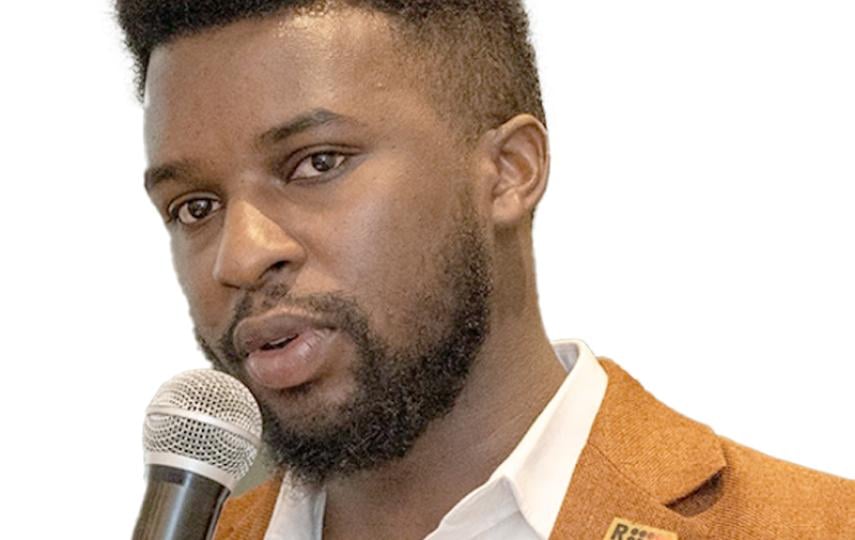 A headshot showing Ishimwe Jean-Marie speaking into a microphone.