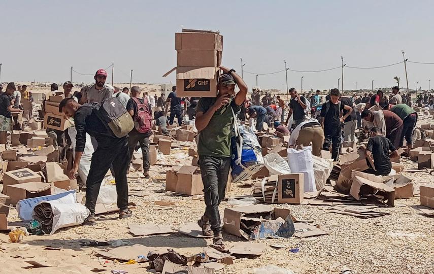 Palestinians collect supplies from a distribution centre run by the Gaza Humanitarian Foundation in the southern Gaza Strip, on 5 June 2025. Over 500 Palestinians have been killed by Israeli forces near these distribution points since 27 May.