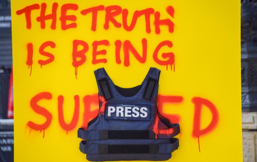 A sign with a protective press vest stating 'The truth is being suppressed' forms part of an installation from Amnesty International, in collaboration with the House of Oddities Agency, unveiled at South Bank on the eve of World Press Freedom Day.