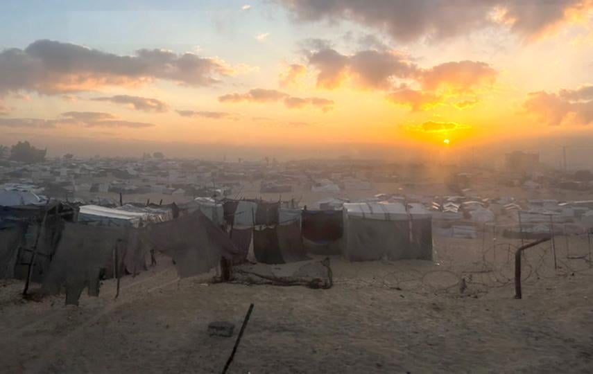 The sunrise over a tent camp housing displaced Palestinians in Khan Younis, taken from the bus as Nour ElAssy was leaving the Gaza Strip.