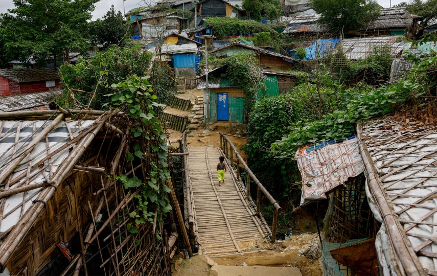 A Rohingya child walks on the bamboo made bridge at a refugee camp, in Cox's Bazar, Bangladesh, September 30, 2024.