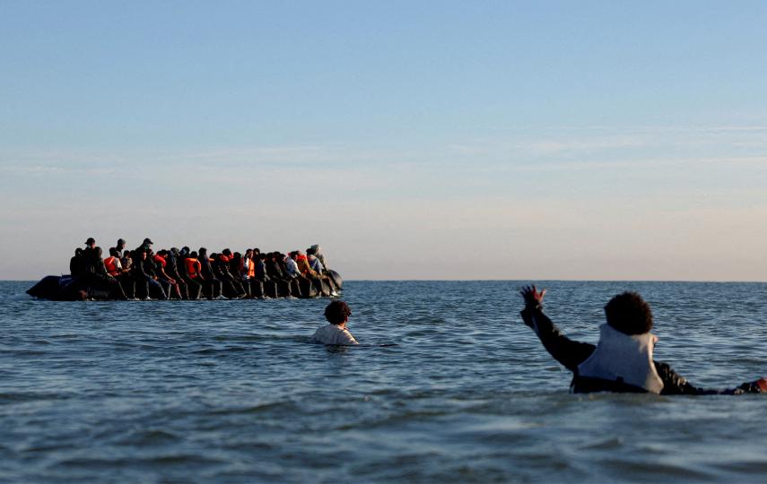 A group of people on an inflatable dinghy leave the coast of northern France in an attempt to cross the English Channel to reach the United Kingdom on 25 August.