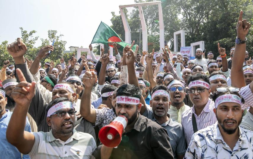 MPO-enlisted teachers of non-government educational institutions chant and wave flags during a protest at Central Shaheed Minar on October 21, 2025 in Dhaka, Bangladesh.