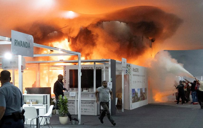 People use fire extinguishers to put out a fire at the Pavilion of Countries in the Blue Zone at the United Nations Climate Change Conference (COP30) in Belem, Brazil, November 20, 2025.