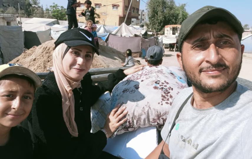 Rasha Abou Jalal, her husband, Abdullah, and one of their children on the back of the truck they rented to carry their belongings to an apartment they rented in Gaza City nearly two months after they were displaced.