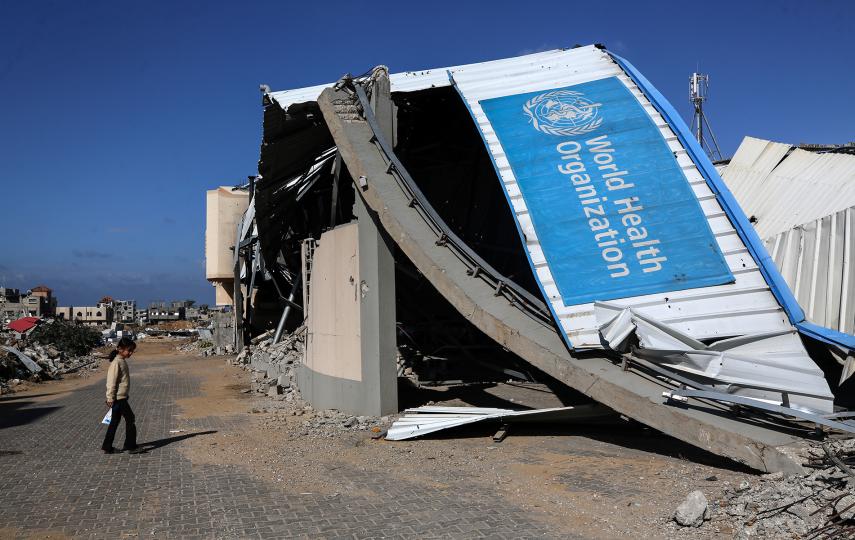 A displaced Palestinian girl walks past a damaged World Health Organisation storage center hit in recent Israeli bombardment in Khan Yunis, Gaza Strip, on November 19, 2024, amid the ongoing war between Israel and the Palestinian Hamas militant group.