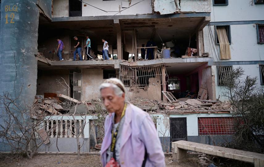 People look for personal belongings through the rubble of a building, following U.S. strikes on Venezuela during which President Nicolas Maduro and his wife, Cilia Flores, were captured, in Catia La Mar, Venezuela, January 4, 2026.