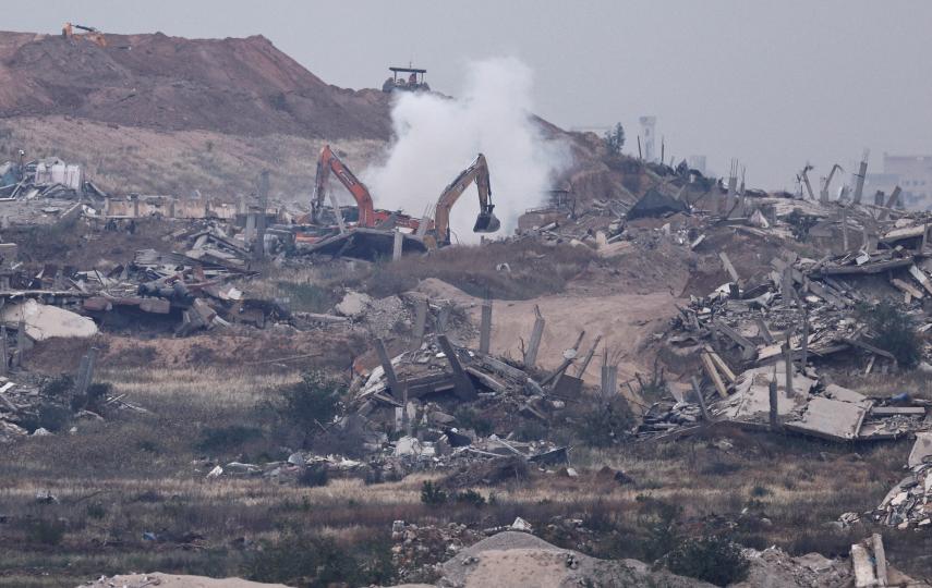 A construction machine works amid rubble in Gaza