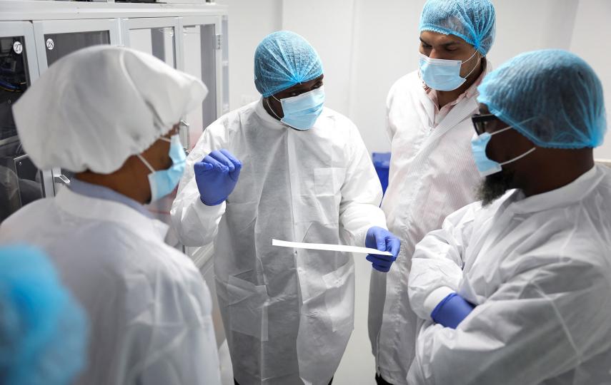 Workers interact beside a machine at Codix Bio production plant where HIV and Malaria test kits are locally produced, as it aims to fill the gap left by U.S. funding cuts to USAID, in Iperu-Remo in Ogun State, Nigeria, June 18, 2025. 