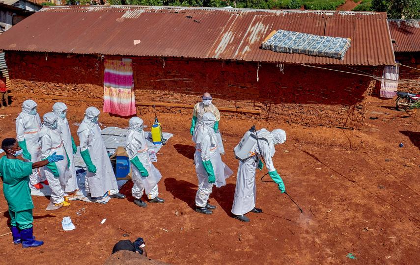 Red Cross workers disinfect the ground outside the house of an unidentified man who died of Ebola, before retrieving his body, in Ituri province's Djugu territory, on 24 May 2026.
