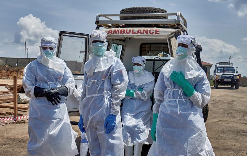 Red Cross workers wearing personal protective equipment (PPE) gather after handling the coffin of a man who died of Ebola virus, as aid agencies intensify efforts to contain the Ebola outbreak caused by the Bundibugyo virus, in Bunia, Ituri province, Democratic Republic of Congo, June 10, 2026.