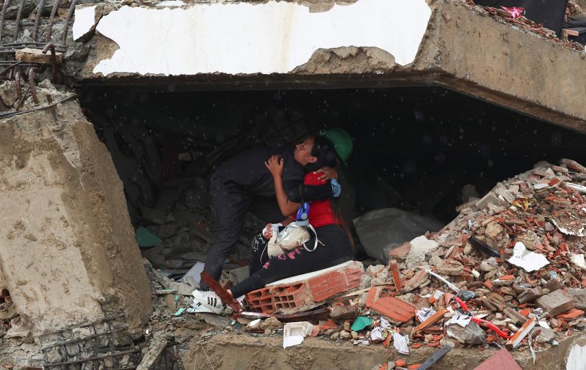 People embrace with rubble around them in La Guaira, Venezuela, 11 July 2026.