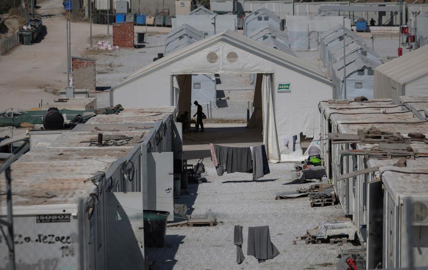 A picture showing a view of tents in refugee camp Kara Tepe. We see the shadow of a person in a tent at the centre of the frame.