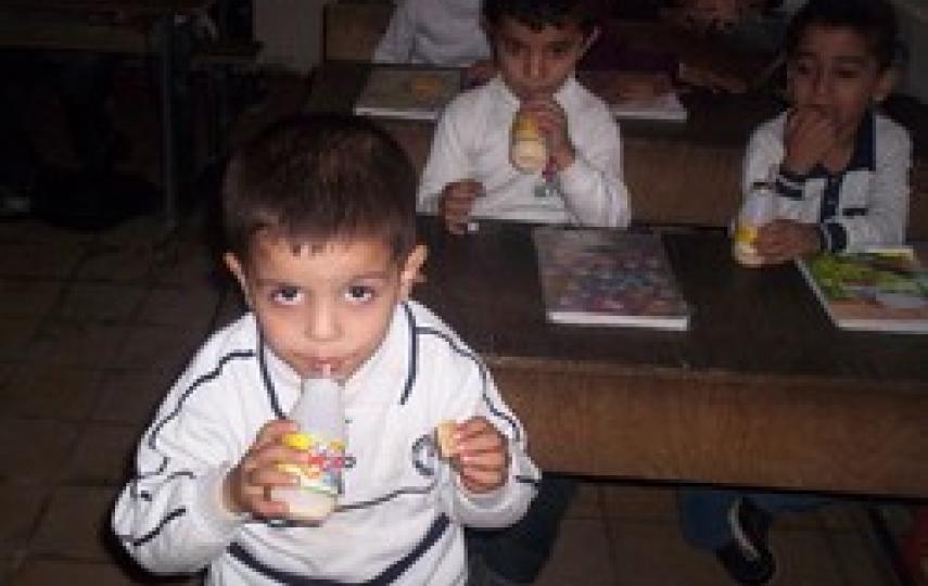 [Iraq] Children at a Baghdad school having their high energy biscuits and milk.