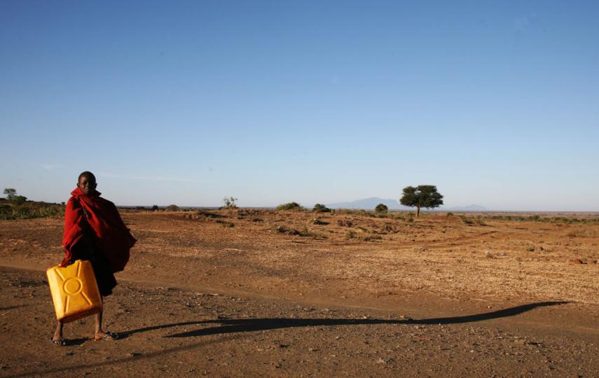 A girl carries water, northeastern Uganda, March 2007. As elsewhere in Africa, the population in eastern Uganda continues to grow as the environment deteriorates, putting more and more pressure on land that grows ever drier. Environmentalists have warned 
