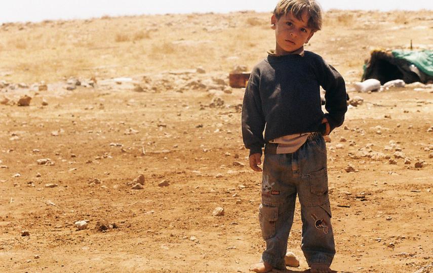 A boy in al-Hadidiya, near his family's tent.