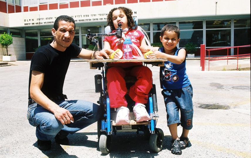 Hamdi Aman, 30, his paralysed daughter Maria, 6, and his son Mo'men, 4.