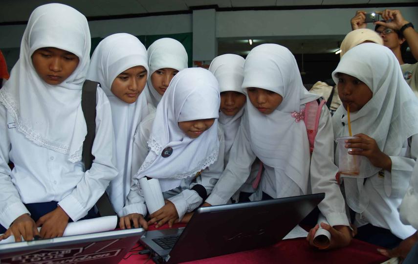 At the National Exhibition of Disaster Preparedness in Padang students watch films that explain the mechanics of earthquakes, tsunamis and other natural disasters.