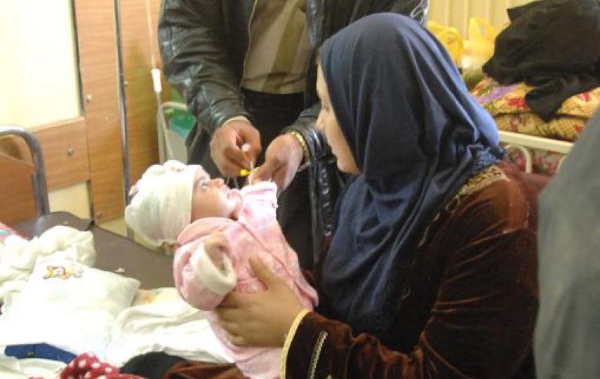 A mother holds her sick baby while an Iraqi doctor gives the child an IV at the Children's Hospital in Muqdadiyah, Iraq. New aid money will go to the most vulnerable Iraqis