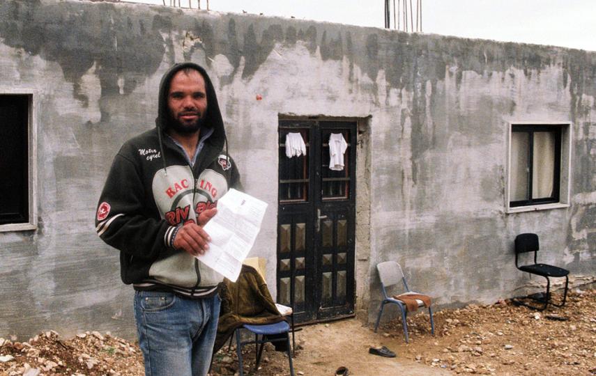 Bilal Jaber stands in front of his house in Beqaa. He is concerned his home will be destroyed and he cannot afford to build a new one.