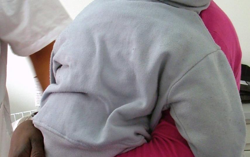 A young Sudanese refugee and her child await medical treatment at a free clinic in Tel Aviv.