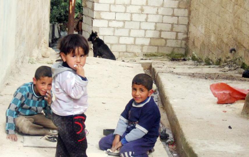 Children in Jerash camp play near a sewage canal, a common scene there.