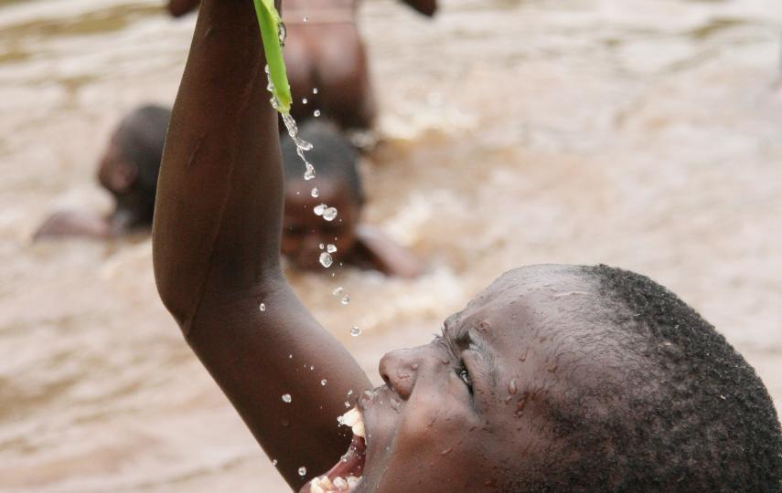 Children play and swim in pools of water that have formed after the rains in the Mathare slums, Kenya. March 2008.