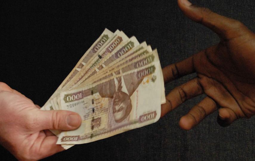Someone recieving a bribe. Corruption is on the increase.
