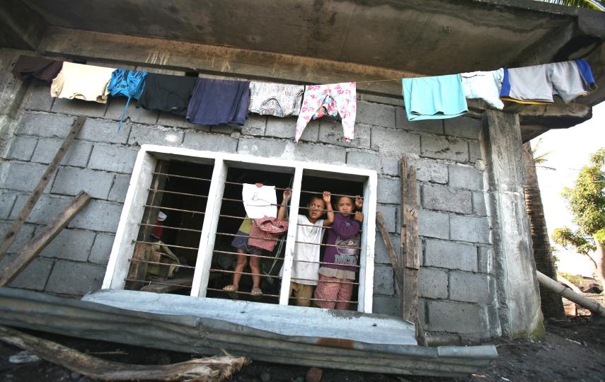 Children in a house damaged by typhoon, Maypon village in the Philippines