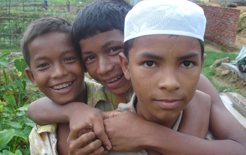 Three Rohingya boys smile to the camera in southern Bangladesh. Muslim residents from Myanmar's northern Rakhine State, the Rohingya are de jure stateless in accordance to the laws of Myanmar