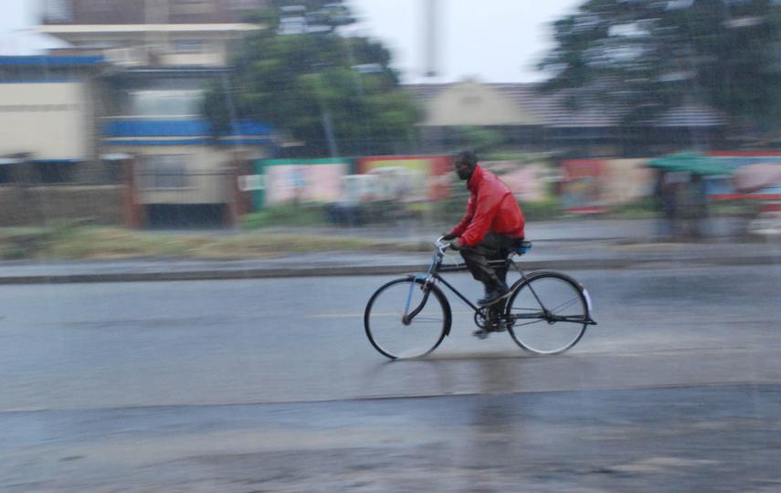 A man cycles home despite the heavy downpour in Nairobi, Kenya 2008. Areas such as Mandera have experiencing heavy rains which could be an effect of climate change.