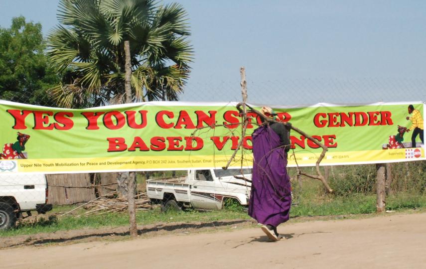 A southern Sudanese woman from the town of Bor looks at banner calling for an end to gender based violence during a November 2008 demonstration