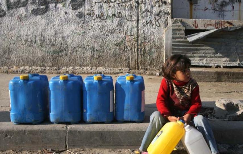 A Palestinian girl in Gaza takes a rest on her way to collect drinking water
