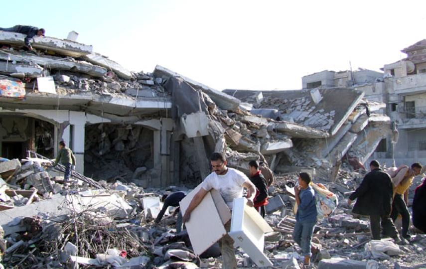 Rafah town residents salvage what they can from the rubble of their homes after Israeli airstrikes in the Gaza Strip