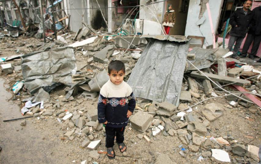 A Palestinian boy stands amid the debris of a destroyed house in Gaza City, near to which two children were killed by UXO recently