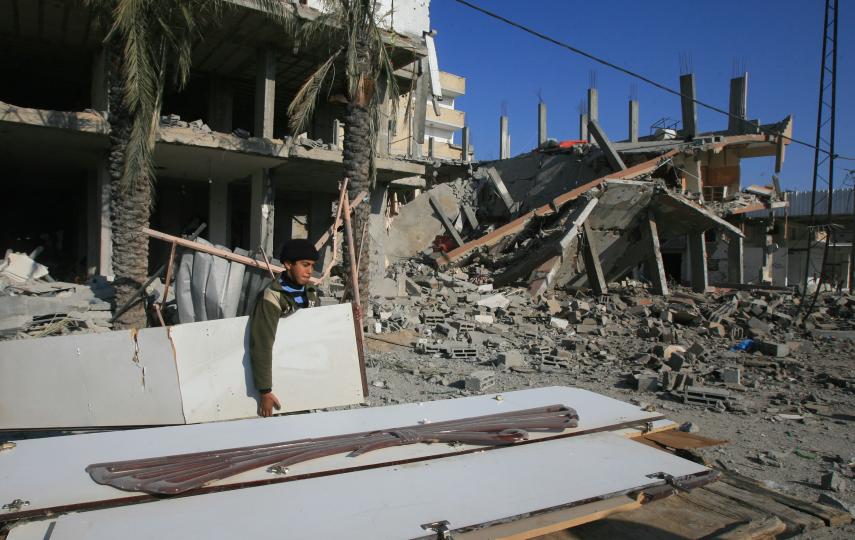 Palestinian families leave their houses after Israeli airstrikes in Rafah near the Gaza Strip's border with Egypt