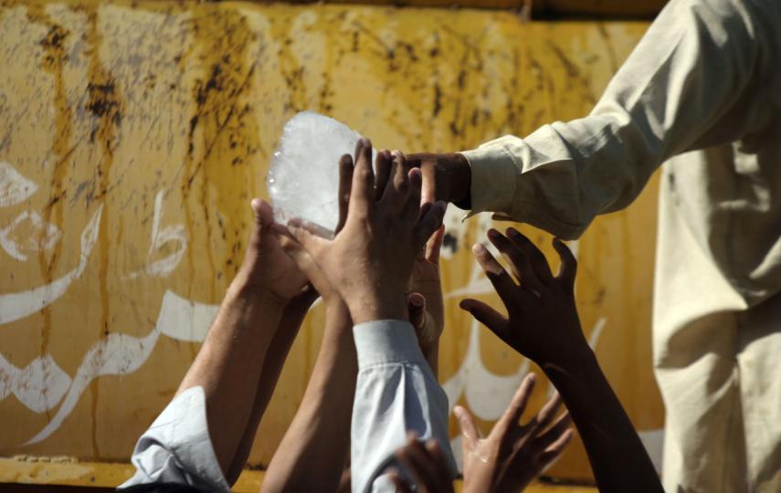 Aid workers hand out ice to IDPs in Jalala camp, Mardan District, North West Frontier Province (NFWP)