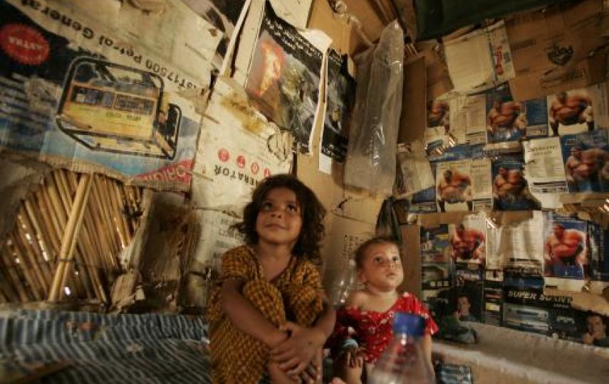 Displaced children sit in their makeshift shelter in an abandoned government building in Baghdad in 2008